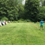 one boy shooting arrow at archery course