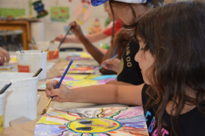 Camper painting at Renbrook Summer Camp