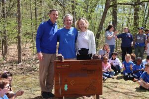 Head of School celebrating trail dedication with teacher and wife