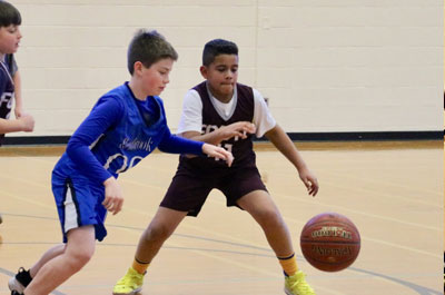 Basketball - Boys Junior Varsity opposing players going after ball