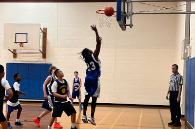 Basketball - Boys Varsity in air shooting ball