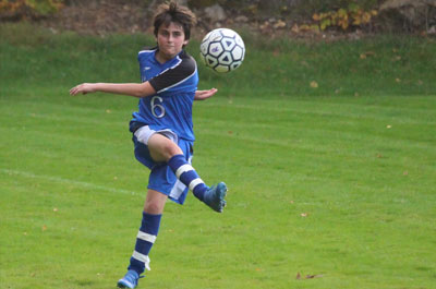 Soccer - Boys Varsity player kicking ball