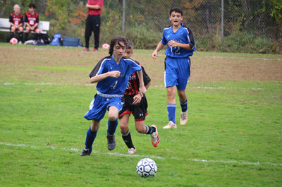 Soccer - Boys Varsity several players running for ball