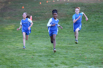 three Cross Country team members coming into finish