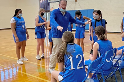 Basketball - Girls Junior Varsity coach talking to players