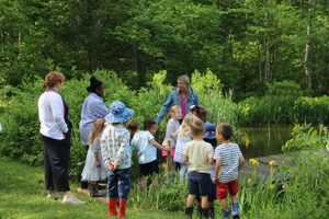 Young students at the pond learning about pond life