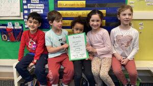 Kindergarten students write animal poem for phonics lesson