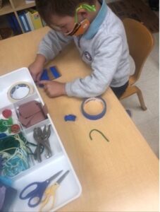 child in mask working on project