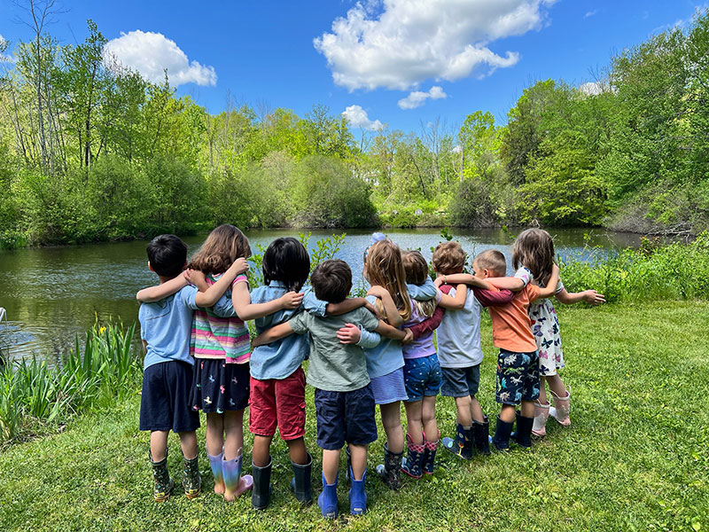 Renbrook students interlocking arms at pond