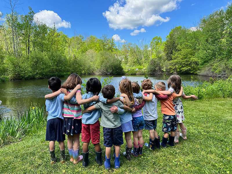 Renbrook students interlocking arms at pond
