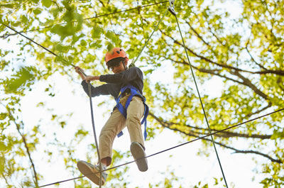 boy balancing on high wire on Renbrook Challenge course