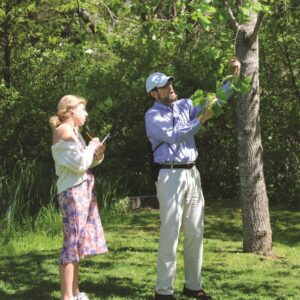 Science teacher explaining tree growth to student