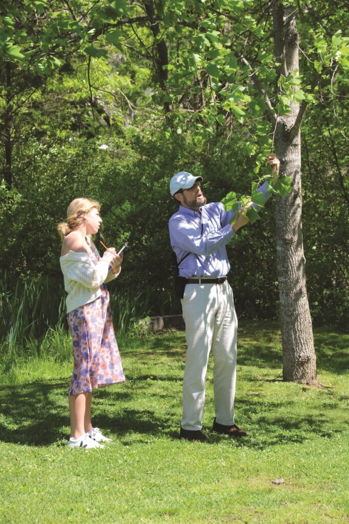Science teacher explaining tree growth to student