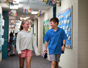 children walking in school hallway