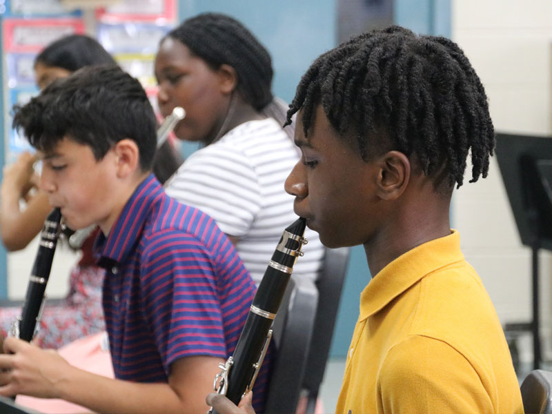 Renbrook students playing instruments in band class