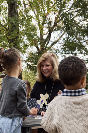 preschool teacher playing with puppets with children