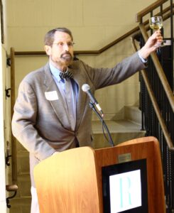 Howard Wright raising a glass for a toast at Alumni Night