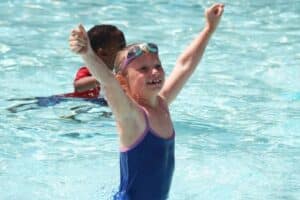 child in pool at camp