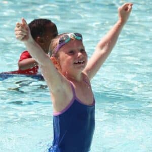 child in pool at camp