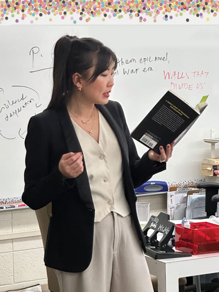 English teacher reading from book