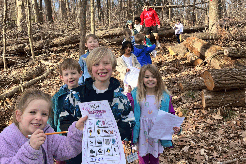 Group of children in the woods doing a scavenger hunt