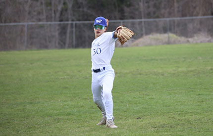 middle school baseball player ready to throw ball