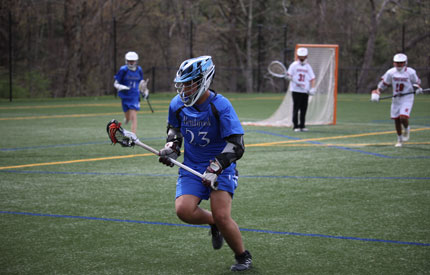 male lacrosse player running down field