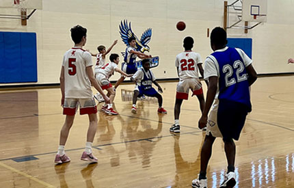 group of boys engaged in basketball game in Renbrook School gym