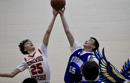 basketball jump shot between 2 middle school boys