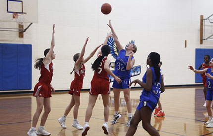 girls basketball players during jump shot