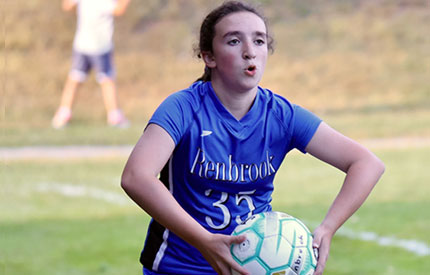 girl ready to throw soccer ball in form the sideline