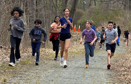 group of students running together through Renbrook School trails
