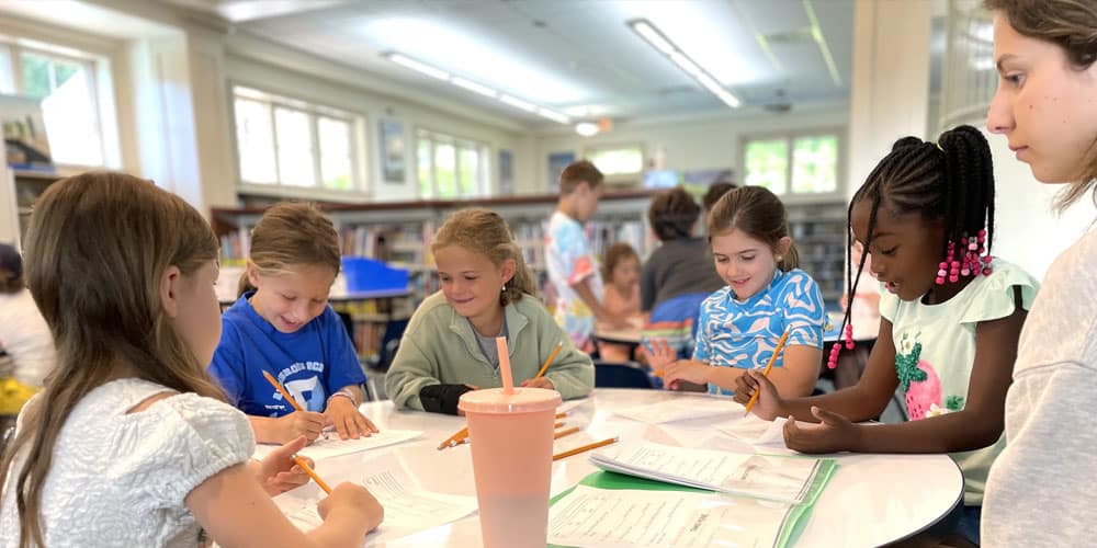 Academic-Adventure-Program group of girls working on writing during Summer Academic Adventure Program