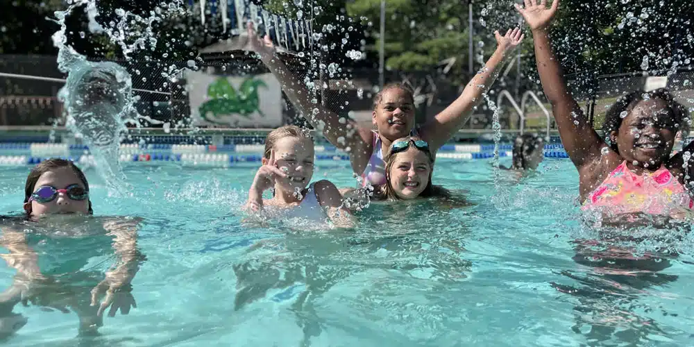 girls splashing in pool