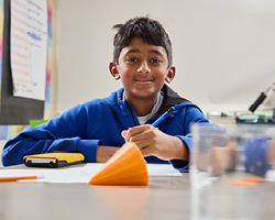 Middle Eatern middle school boy working on an Algebra project