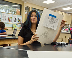 middle school girl showing her art work