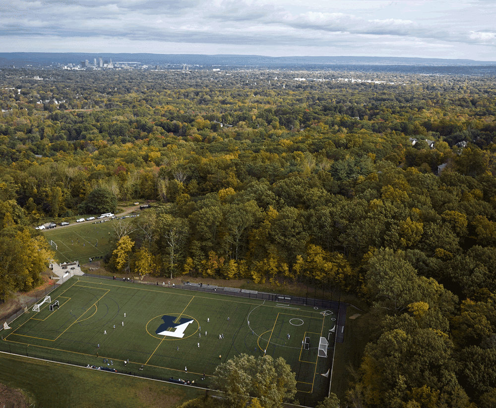Aerial photo of the turf field at Renbrook School with a view to downtown Hartford