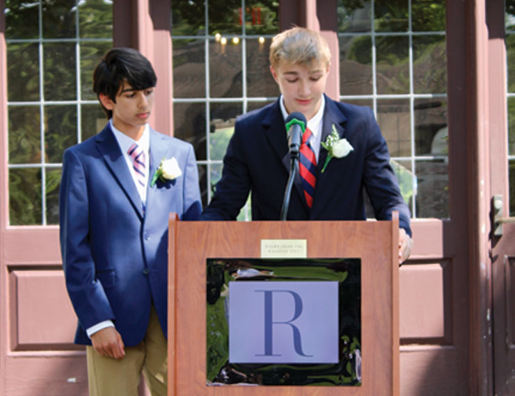 two boys speaking at middle school graduation