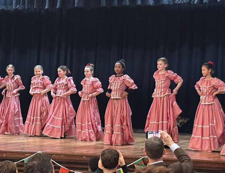 female students performing Cumbia dance