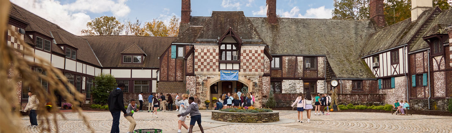 students playing and mingling during recess in Renbrook School's front courtyard