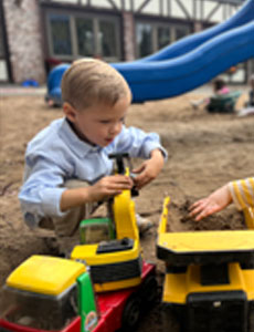 Preschool boy playing with truck