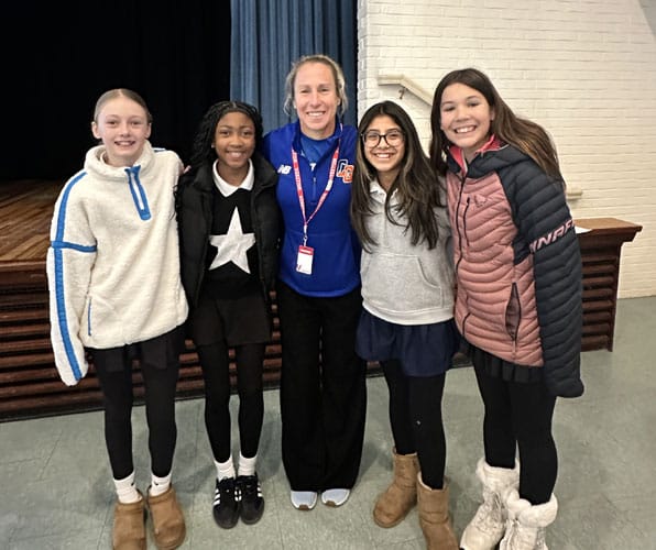 four female students with marathon great race runner