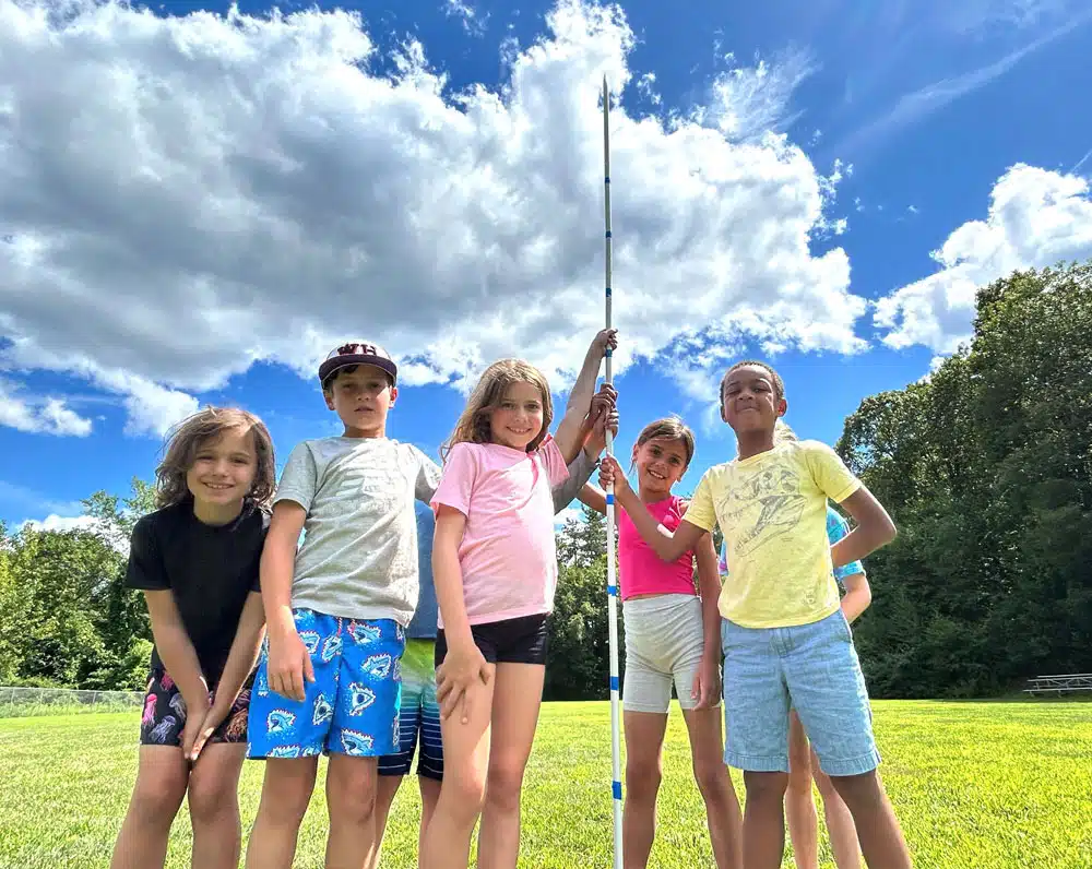 5 pre-teens engaged in rocketry at summer camp