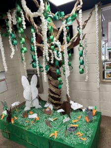 beautiful tree and garden created out of paper and cardboard to celebrate the Week of the Young Child
