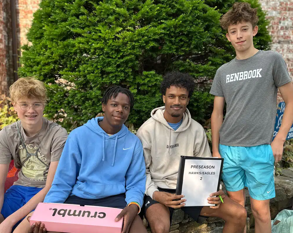 three teen boys and male counselor at pre-season camp at Renbrook Summer Adventure