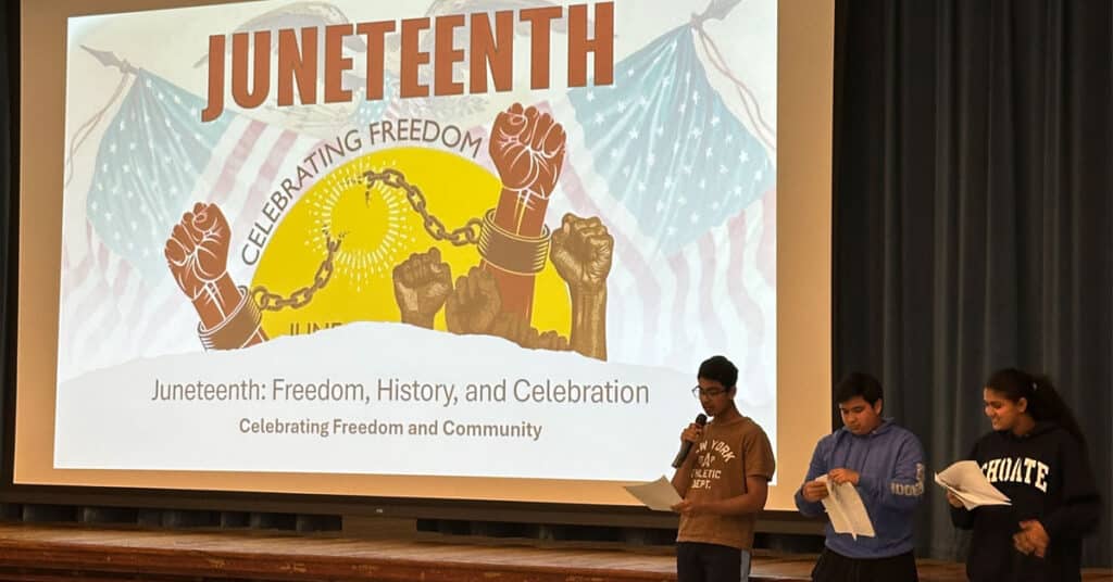 Three students presenting to their peers about Juneteenth