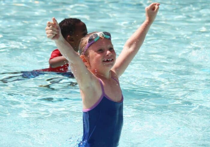 child in pool at camp